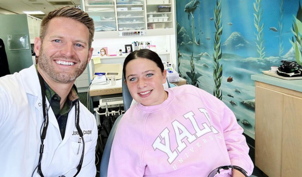 Dr Jordan Colby, orthodontist in Oceanside CA, with a smiling patient
